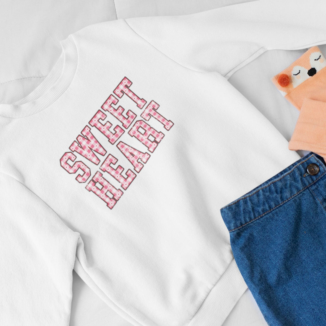 child size white sweatshirt with the words SWEET HEART