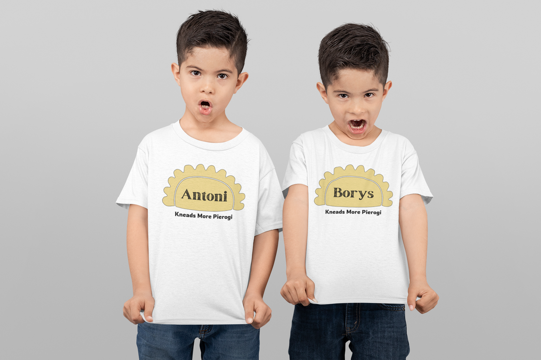 Two small boys holing onto t-shirts that show a Pierogi and stating their name