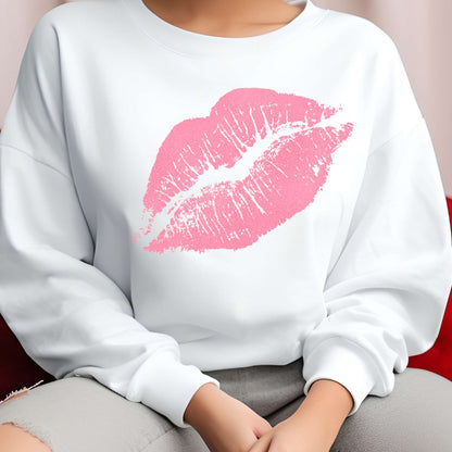 White sweatshirt with a pink lipstick print worn by a person.