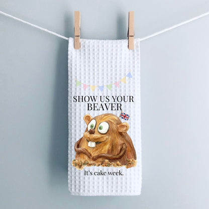 White waffle-textured towel with a cartoon beaver and text on a gray background