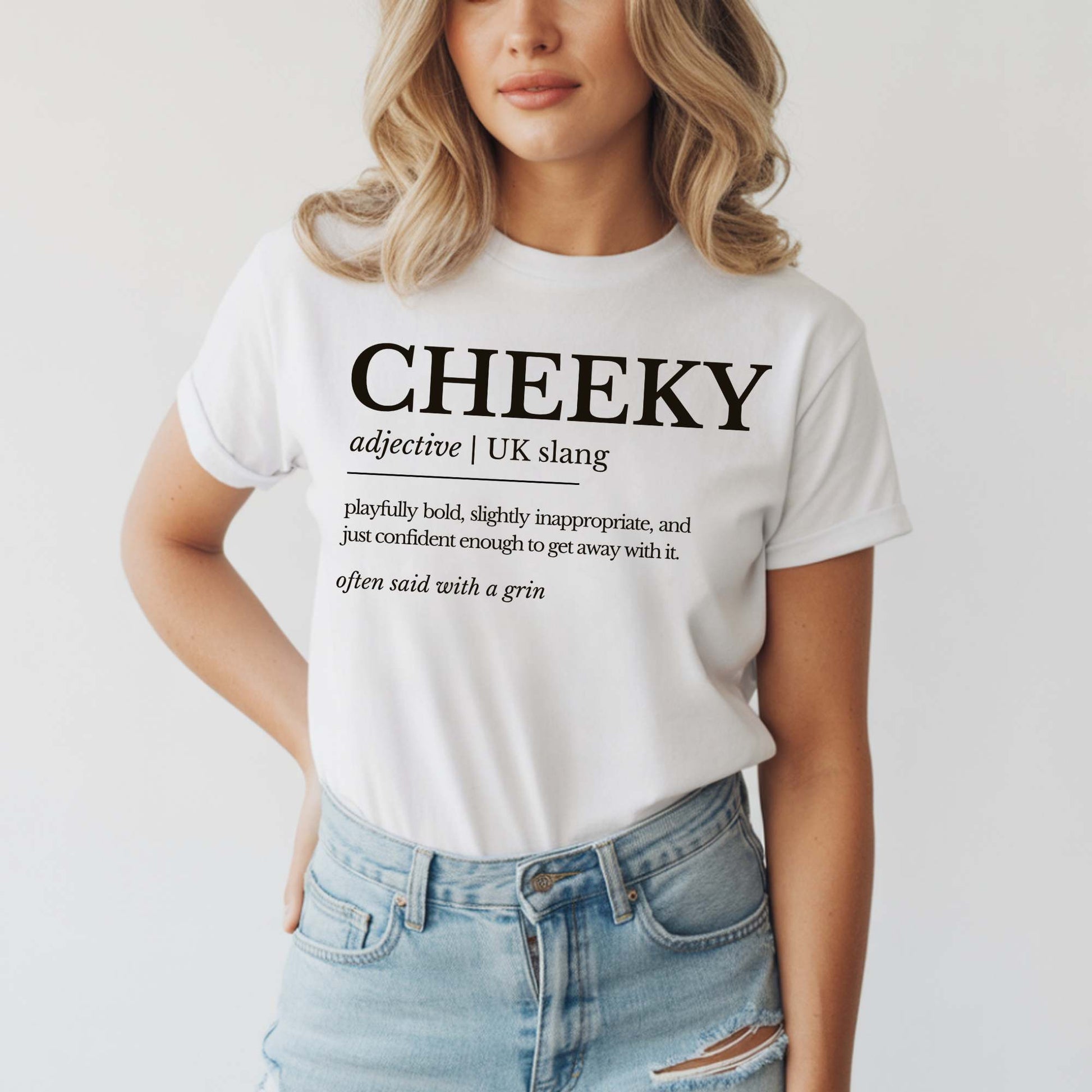 Person wearing a white t-shirt with 'CHEEKY' definition text on a plain background. 