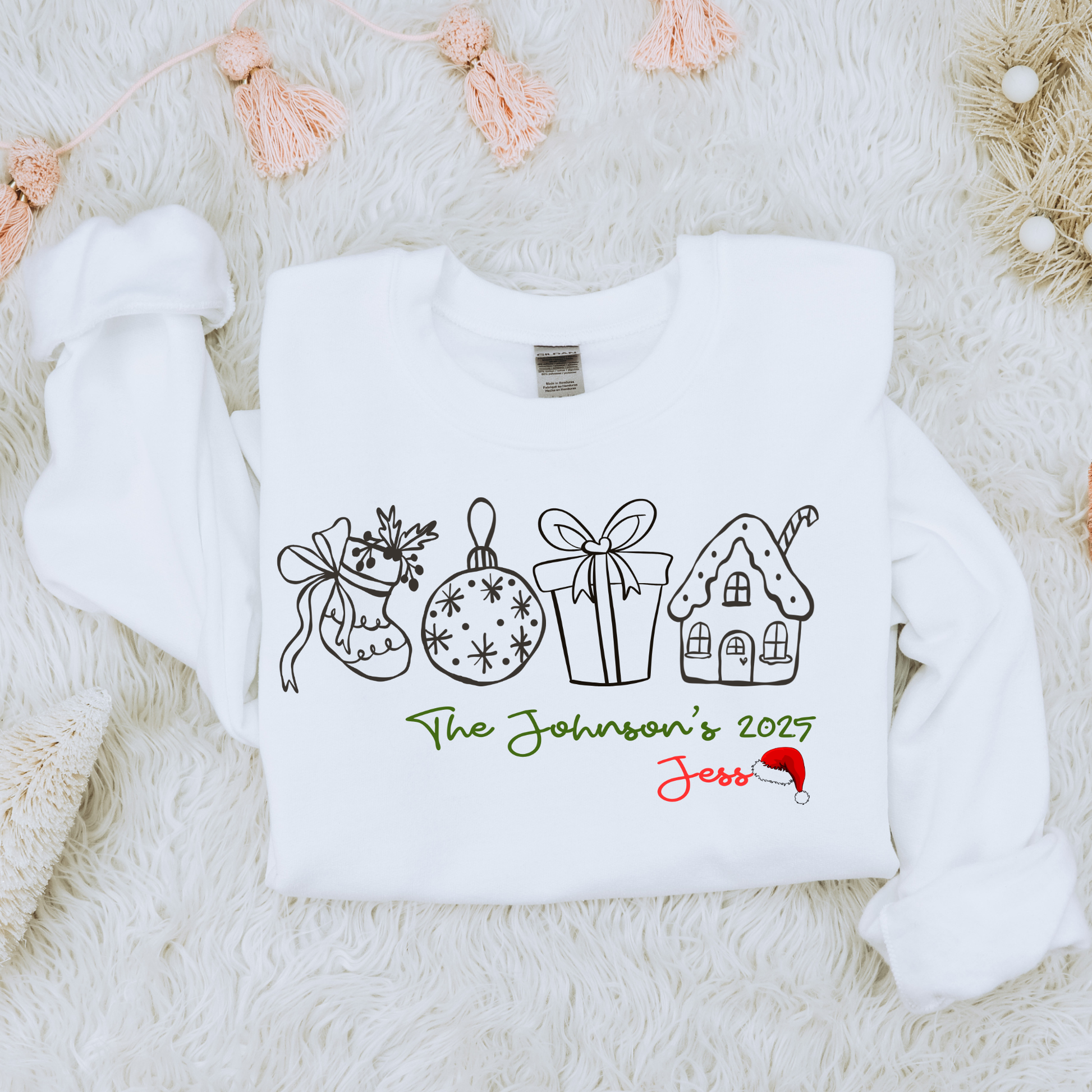 Personalized Family Christmas Sweatshirt featuring whimsical line-art icons and custom family name, year, and individual name