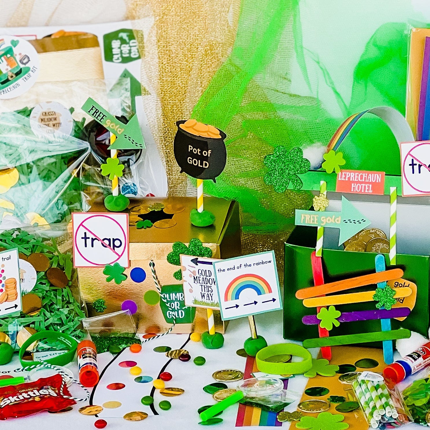 Two boxes green and gold with craft contents to make a leprechaun trap