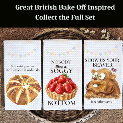 Three kitchen towels with humorous designs inspired by 'The Great British Bake Off'.