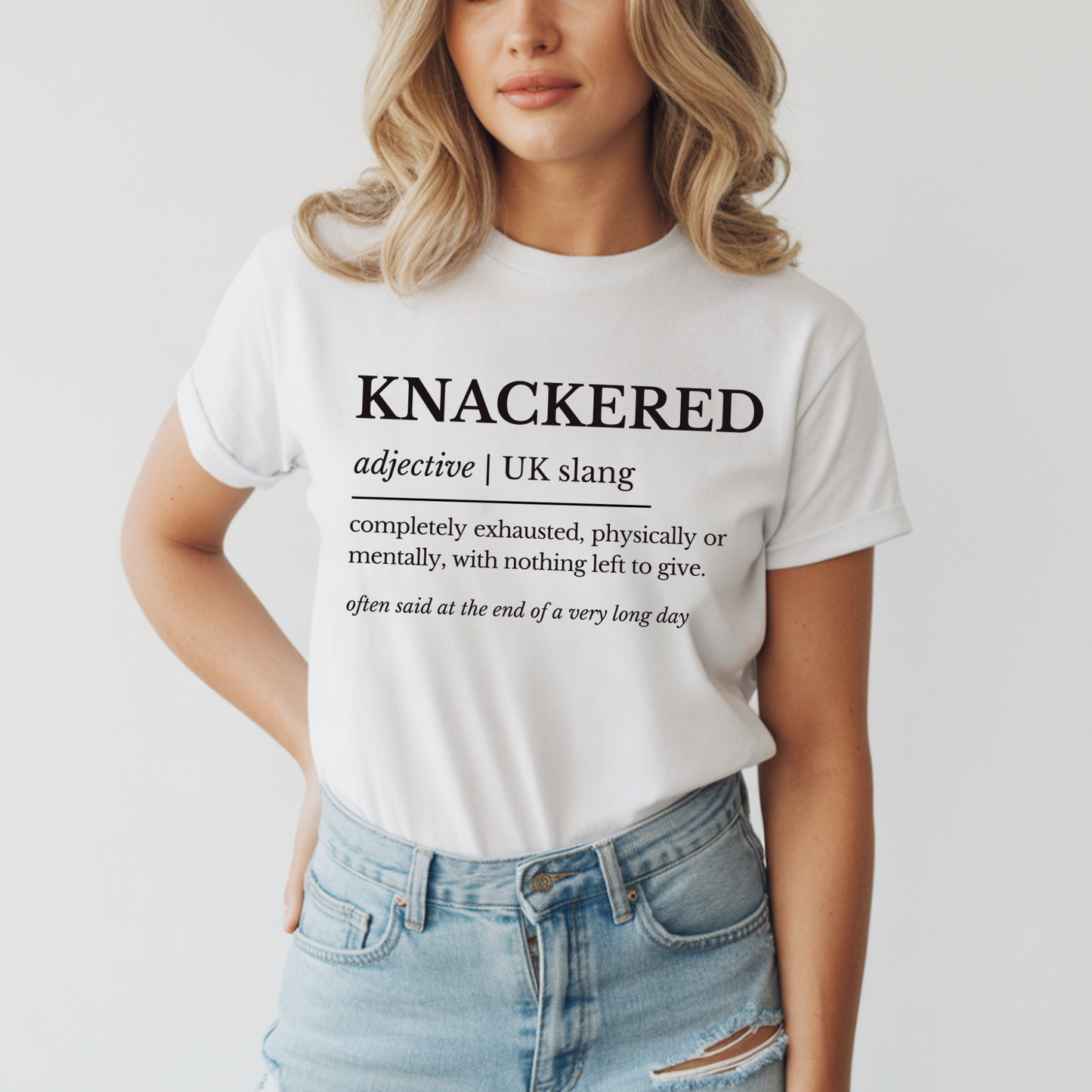 Person wearing a white t-shirt with 'KNACKERED' definition text on a plain background