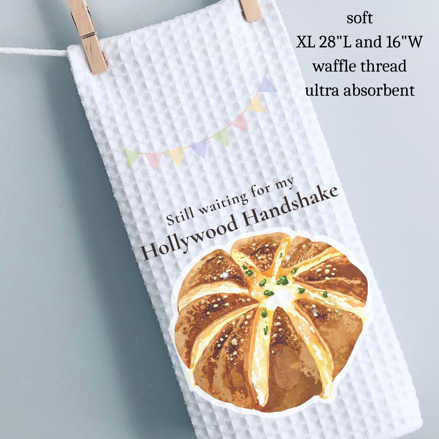 Waffle-textured towel with bread graphic and text on a gray background